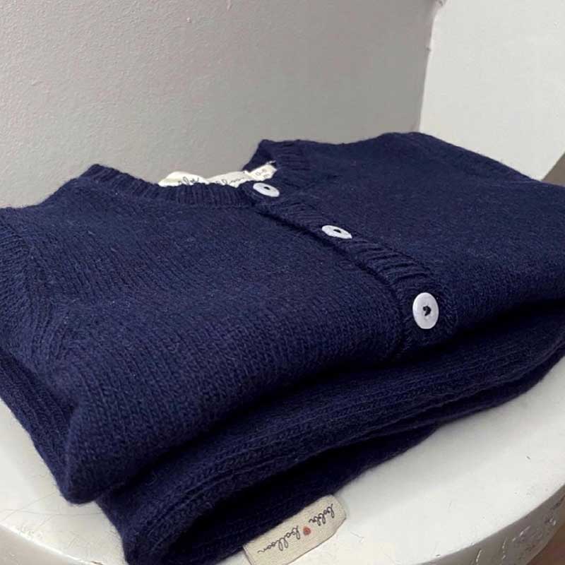 A sophisticated image highlighting "The Classy Cardigan," a garment that embodies effortless elegance with its refined design. This versatile cardigan adds a touch of sophistication to any ensemble, making it a wardrobe essential for timeless style.