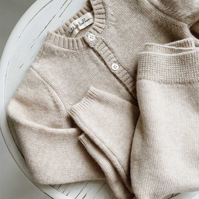 A sophisticated image highlighting "The Classy Cardigan," a garment that embodies effortless elegance with its refined design. This versatile cardigan adds a touch of sophistication to any ensemble, making it a wardrobe essential for timeless style.