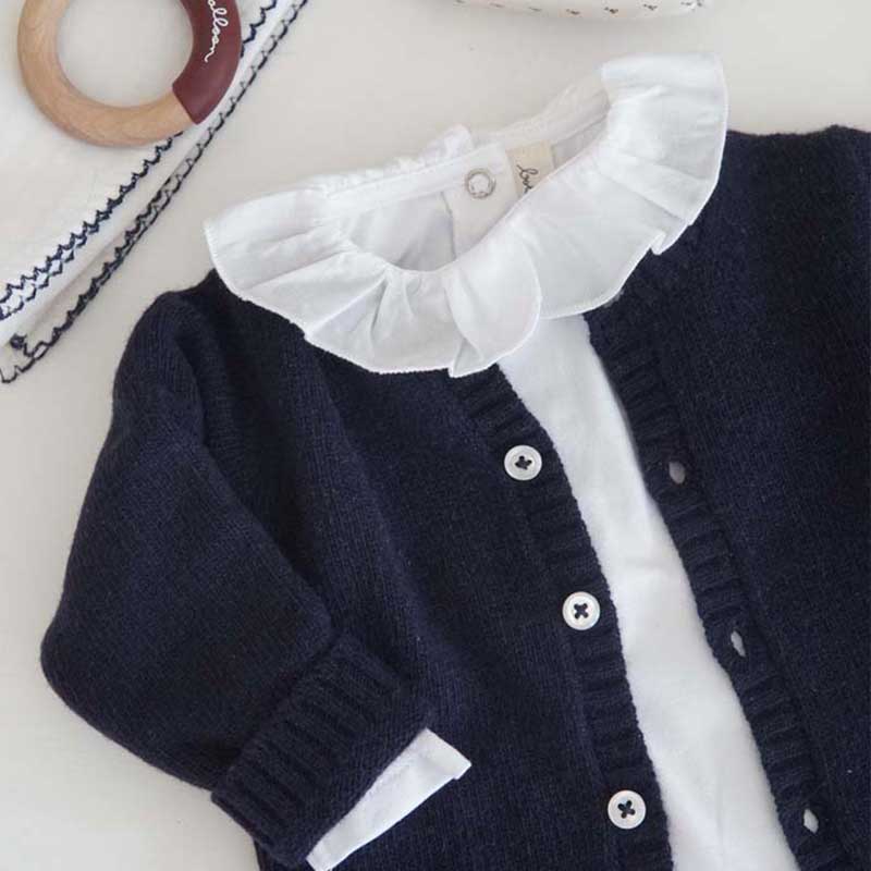 A sophisticated image highlighting "The Classy Cardigan," a garment that embodies effortless elegance with its refined design. This versatile cardigan adds a touch of sophistication to any ensemble, making it a wardrobe essential for timeless style.
