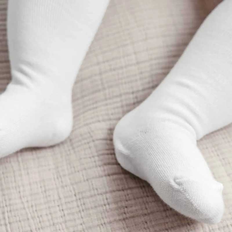 A charming display of baby tights in various colors and patterns, designed for comfort and style. These soft and cozy tights ensure your little one stays warm and fashionable during every adorable adventure.