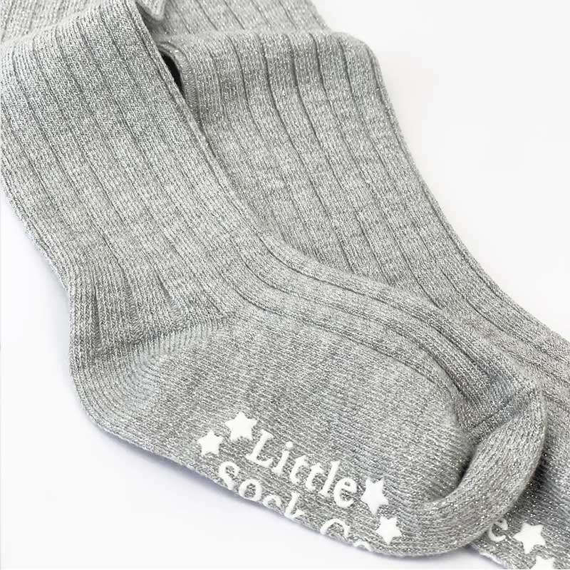  A delightful image showcasing "The Glitter Rib Tights," adorable children's tights with a ribbed texture and a touch of sparkling glitter. These tights add a playful and stylish element to any little one's outfit.