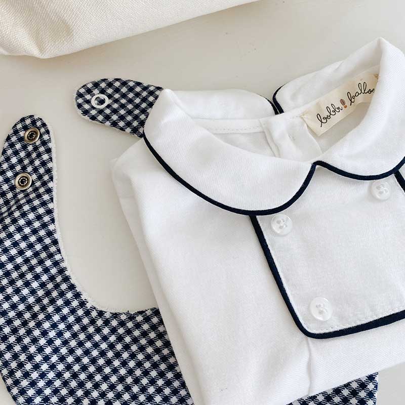 A sophisticated image featuring "The Vichy Neck Scarf," a stylish accessory adorned with a timeless checked pattern. This versatile scarf adds a touch of elegance to any outfit, making it a chic and classic addition to your accessory collection.