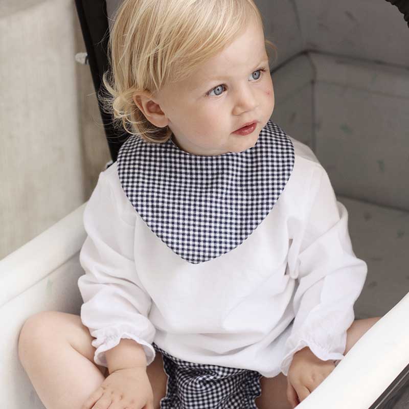 A sophisticated image featuring "The Vichy Neck Scarf," a stylish accessory adorned with a timeless checked pattern. This versatile scarf adds a touch of elegance to any outfit, making it a chic and classic addition to your accessory collection.
